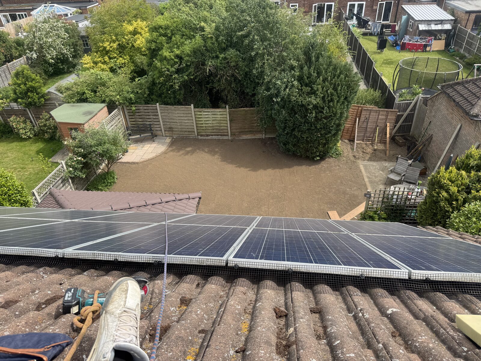 Rear garden cleared to bare, levelled soil ready for new turf, seen from roof level